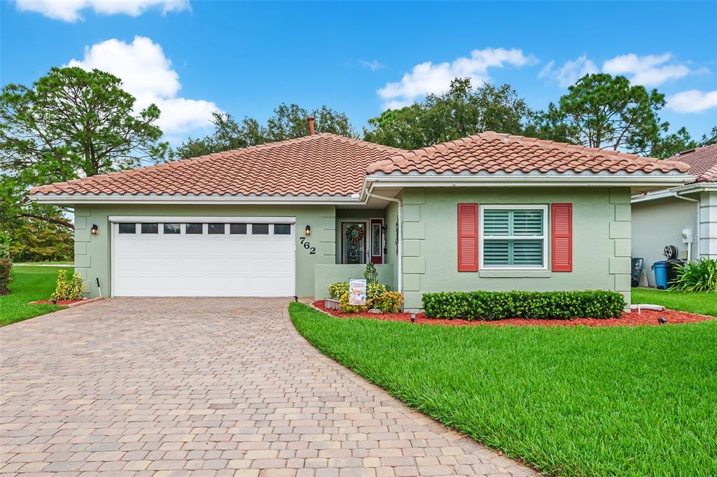 762 Canberra Road Winter Haven, FL 33884 - Photo 1 of 1 a front view of a house with a garden