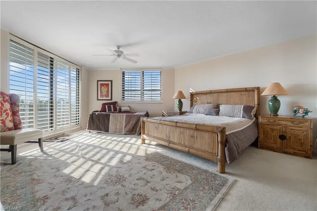 a bedroom with a large bed and wooden floor
