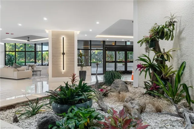 a lobby with furniture and floor to ceiling window