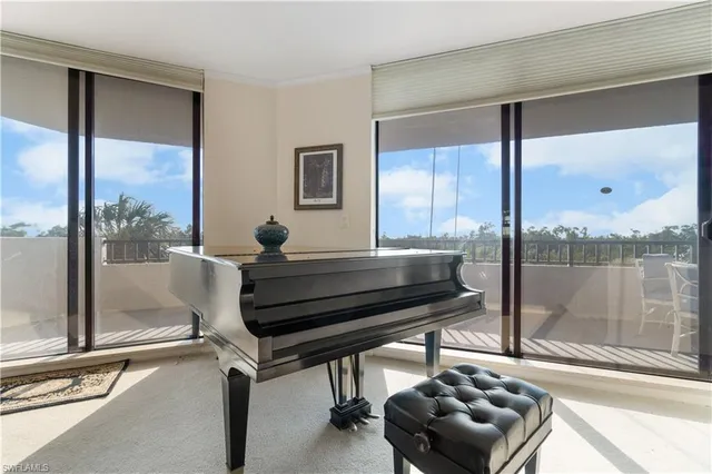 a living room with a couch a table and a large window