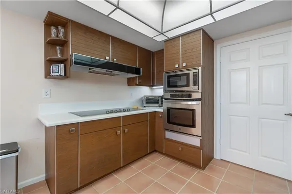 a kitchen with cabinets and steel stainless steel appliances