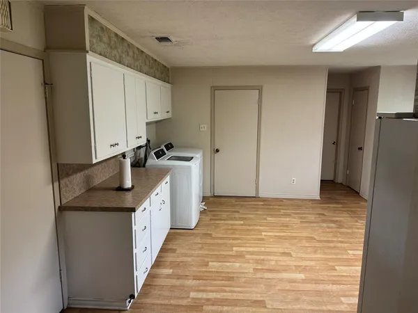 a kitchen with granite countertop a sink and refrigerator