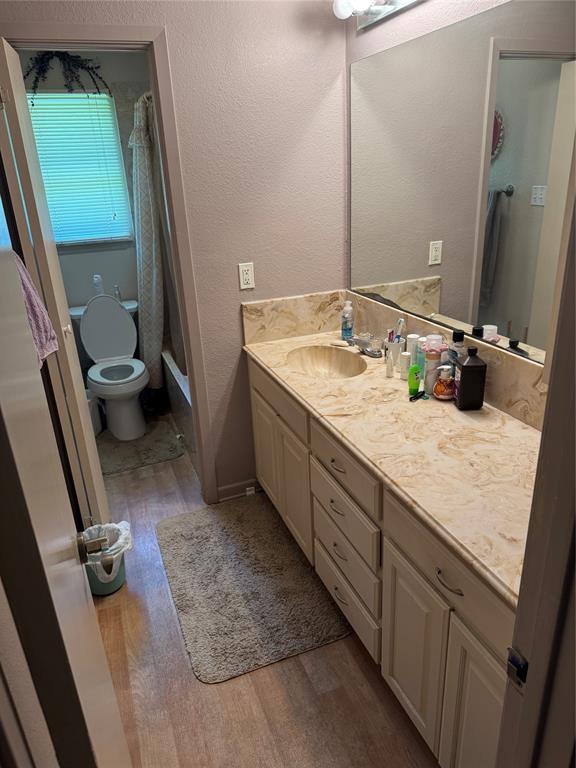 1910 Jefferson Street Commerce, TX 75428 - Photo 15 of 16 a bathroom with a granite countertop sink and a mirror