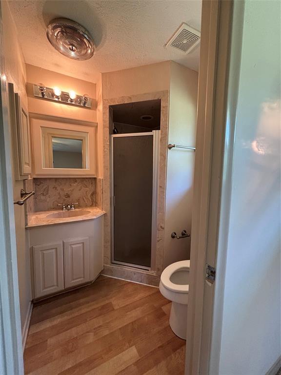 1910 Jefferson Street Commerce, TX 75428 - Photo 2 of 16 a bathroom with a granite countertop sink toilet and shower