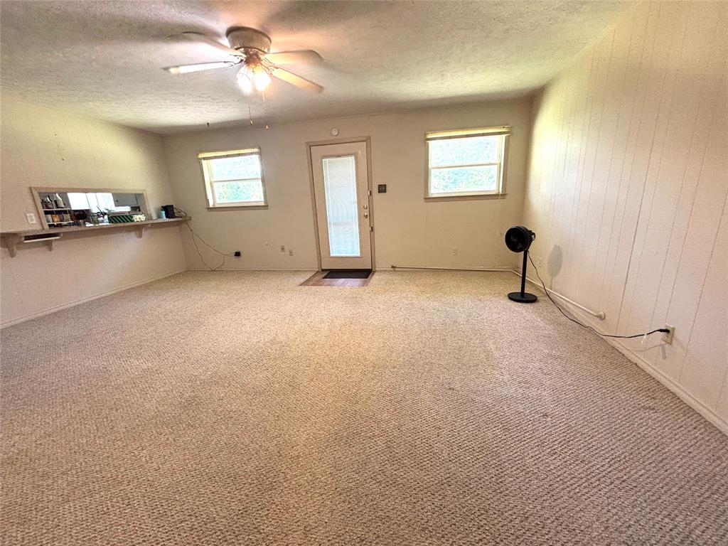 1910 Jefferson Street Commerce, TX 75428 - Photo 10 of 16 a view of a livingroom with furniture ceiling fan and window