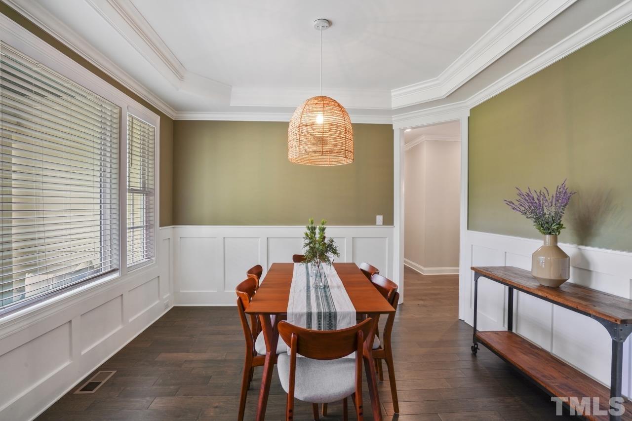 8600 Flannery Court Knightdale, NC 27545 - Photo 13 of 36 a view of a dining room with furniture and a chandelier