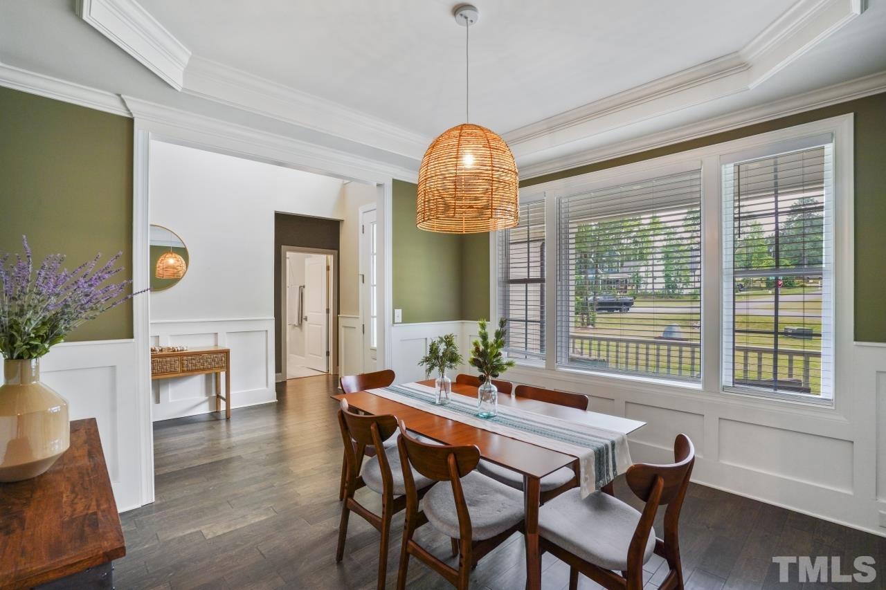 8600 Flannery Court Knightdale, NC 27545 - Photo 14 of 36 a dining room with furniture a chandelier and wooden floor