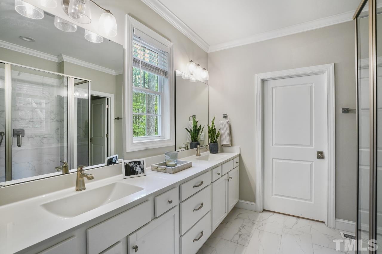 8600 Flannery Court Knightdale, NC 27545 - Photo 18 of 36 a bathroom with a double vanity sink mirror and double