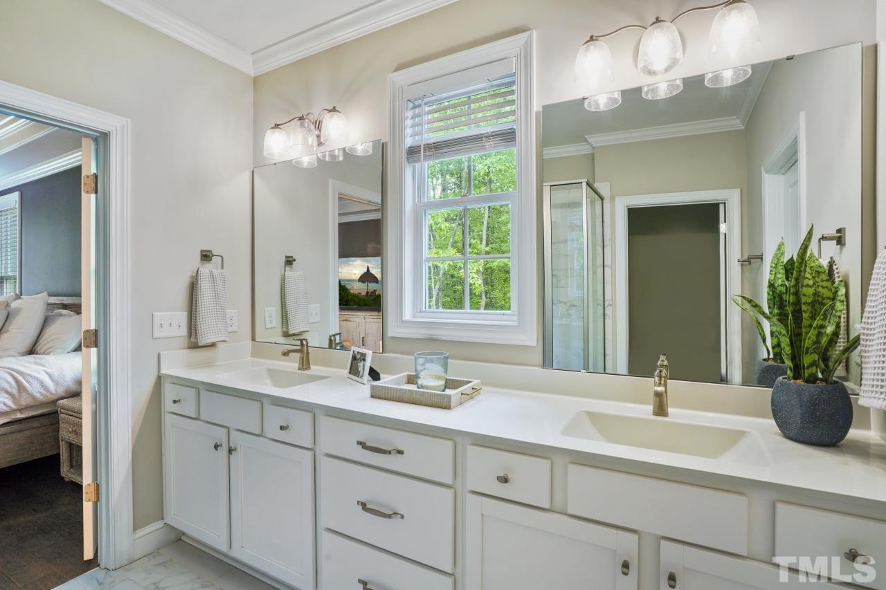 8600 Flannery Court Knightdale, NC 27545 - Photo 19 of 36 a bathroom with double vanity and a mirror