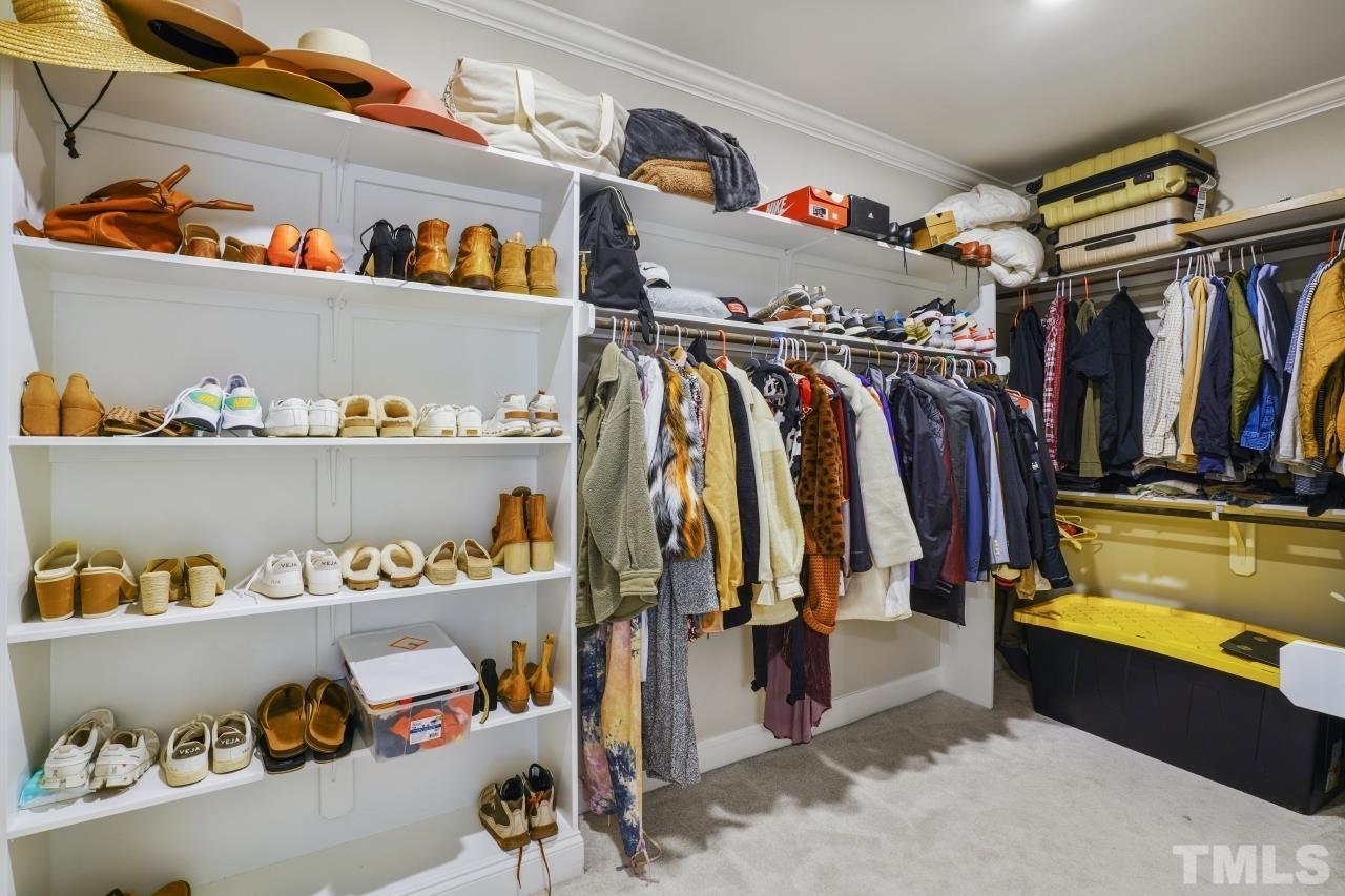 8600 Flannery Court Knightdale, NC 27545 - Photo 20 of 36 a view of walk in closet with clothes and shoes