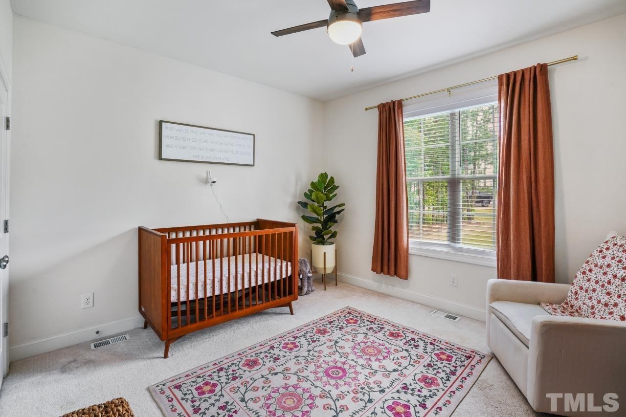 8600 Flannery Court Knightdale, NC 27545 - Photo 21 of 36 a bedroom with a couch and a rug
