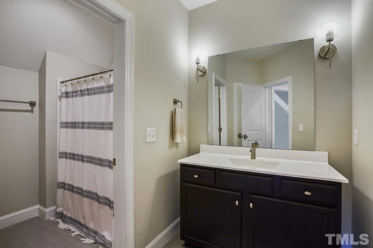 8600 Flannery Court Knightdale, NC 27545 - Photo 29 of 36 a bathroom with a sink and a mirror
