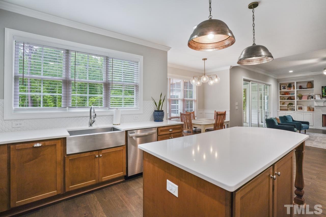 8600 Flannery Court Knightdale, NC 27545 - Photo 10 of 36 a kitchen with stainless steel appliances a sink a counter space and a large window
