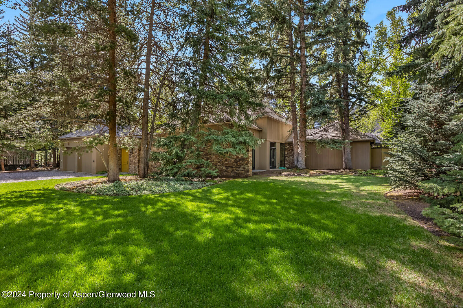 844 Roaring Fork Road Aspen, CO 81611 - Photo 15 of 39 a front view of a house with a yard