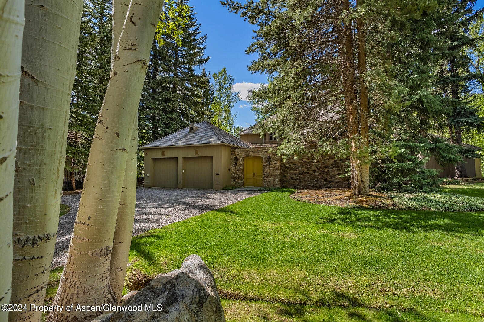 844 Roaring Fork Road Aspen, CO 81611 - Photo 16 of 39 a front view of a house with garden