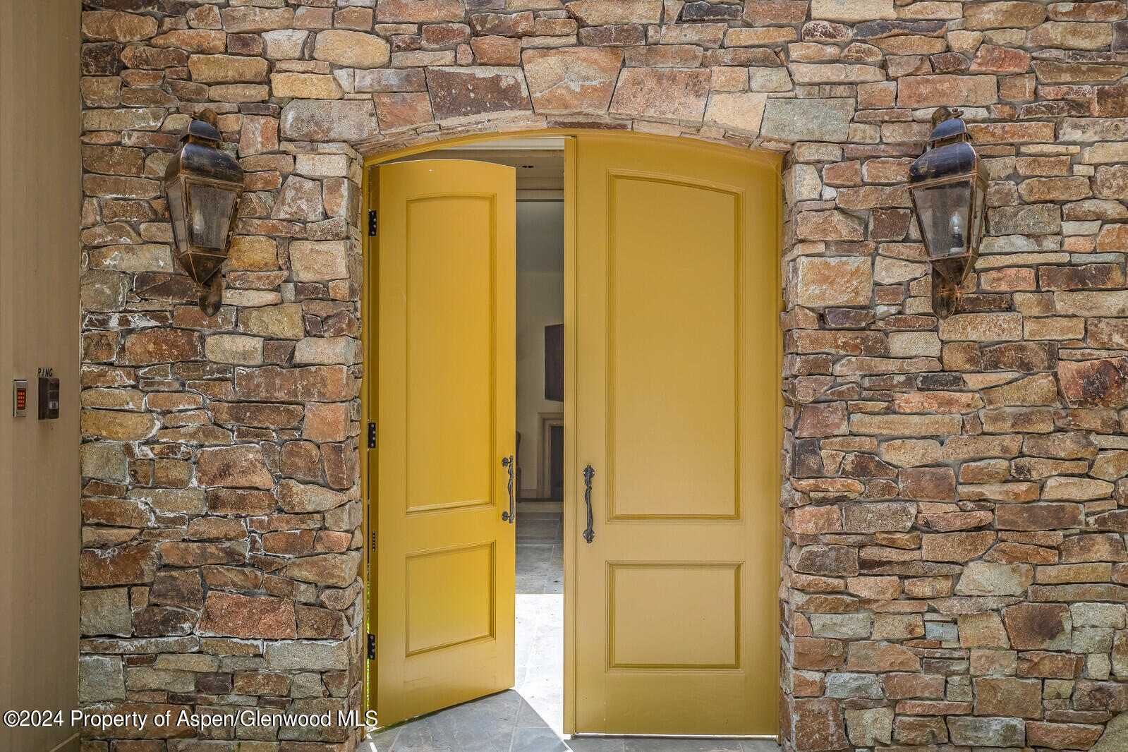 844 Roaring Fork Road Aspen, CO 81611 - Photo 17 of 39 a yellow house with a glass door