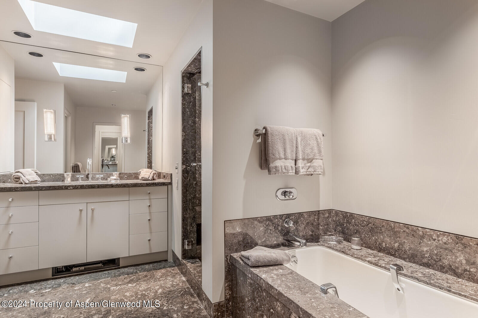 844 Roaring Fork Road Aspen, CO 81611 - Photo 31 of 39 a bathroom with a granite countertop tub sink and mirror