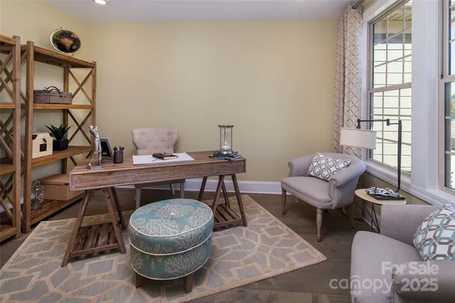 a living room with furniture a rug and a window