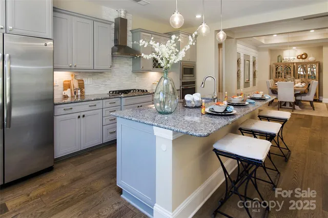 a kitchen with sink refrigerator and cabinets