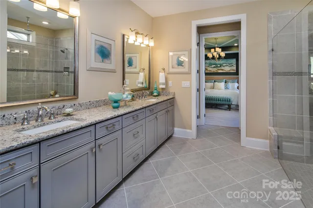 a spacious bathroom with a granite countertop sink mirror and shower