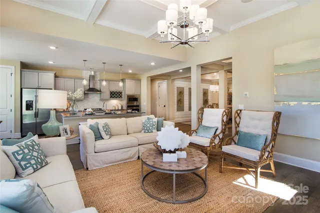 a living room with furniture or kitchen view and a chandelier