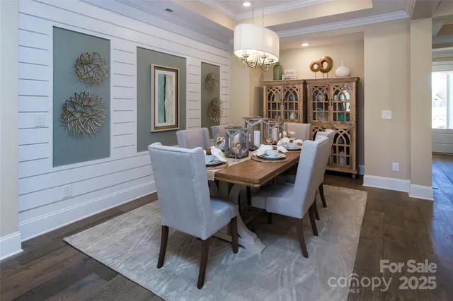 a dining room with furniture a rug and a mirror