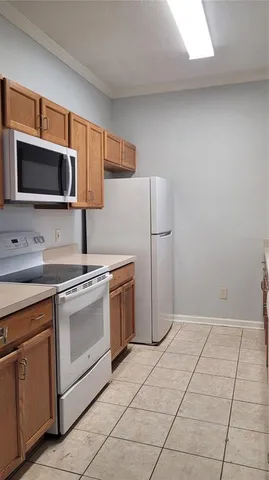 a kitchen with stainless steel appliances granite countertop a refrigerator sink and microwave