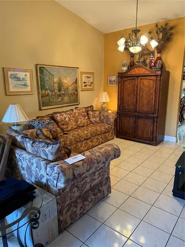 a bedroom with bed and a chandelier