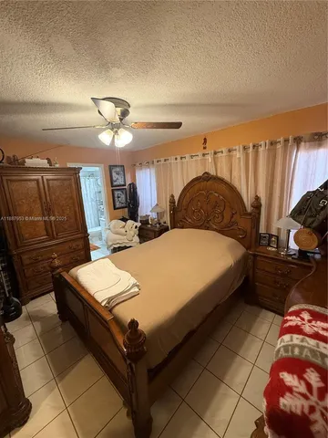 a bedroom with a bed and a mirror