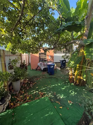 a backyard of a house with table and chairs