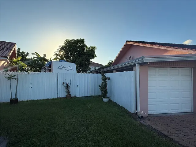 a house that has a small yard and large trees