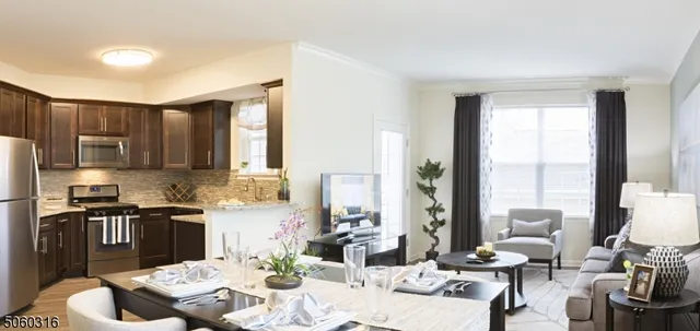 a kitchen with stainless steel appliances kitchen island granite countertop a sink and a refrigerator