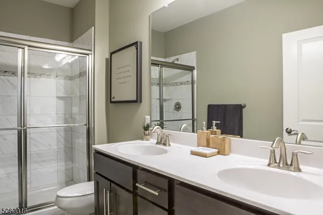 a bathroom with a sink toilet a mirror and shower
