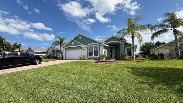 a front view of a house with yard porch and outdoor seating