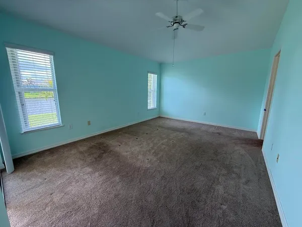 a view of a livingroom with a ceiling fan and window
