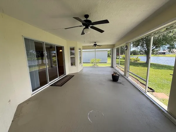 an empty room with floor to ceiling windows and pool table