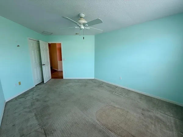 a view of a room with wooden floor and staircase