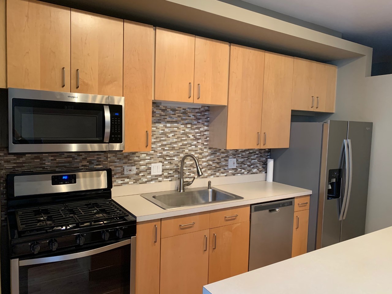 212 West Washington Street, Unit 1106 Chicago, IL 60606 - Photo 7 of 25 a kitchen with stainless steel appliances a stove a sink and a microwave