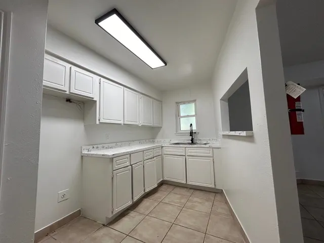 a kitchen with a sink stove and cabinets