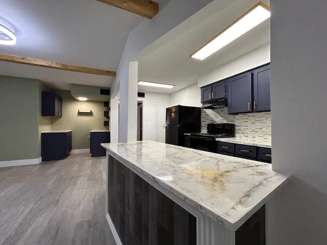 a kitchen with a stove a sink and a refrigerator