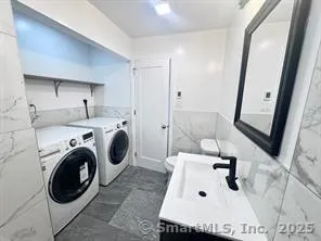 a utility room with sink dryer and washer