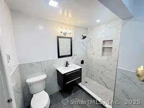 a bathroom with a toilet sink and mirror
