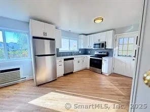a kitchen with a refrigerator a stove top oven and kitchen island