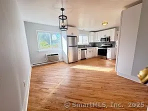 a kitchen with stainless steel appliances a refrigerator and a stove top oven