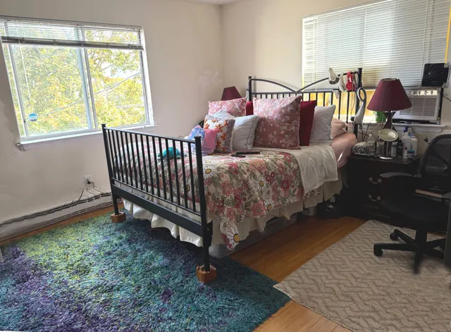 a bathroom with a granite countertop toilet and a sink