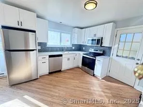 a kitchen with a refrigerator a sink and dishwasher