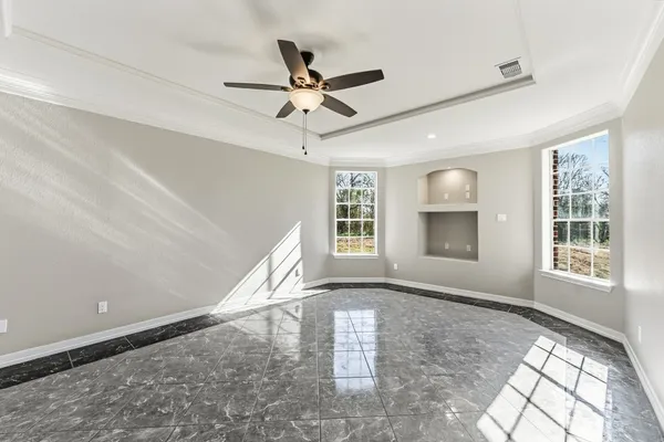 a view of a livingroom with a ceiling fan and window