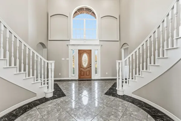a view of staircase with white walls and a window