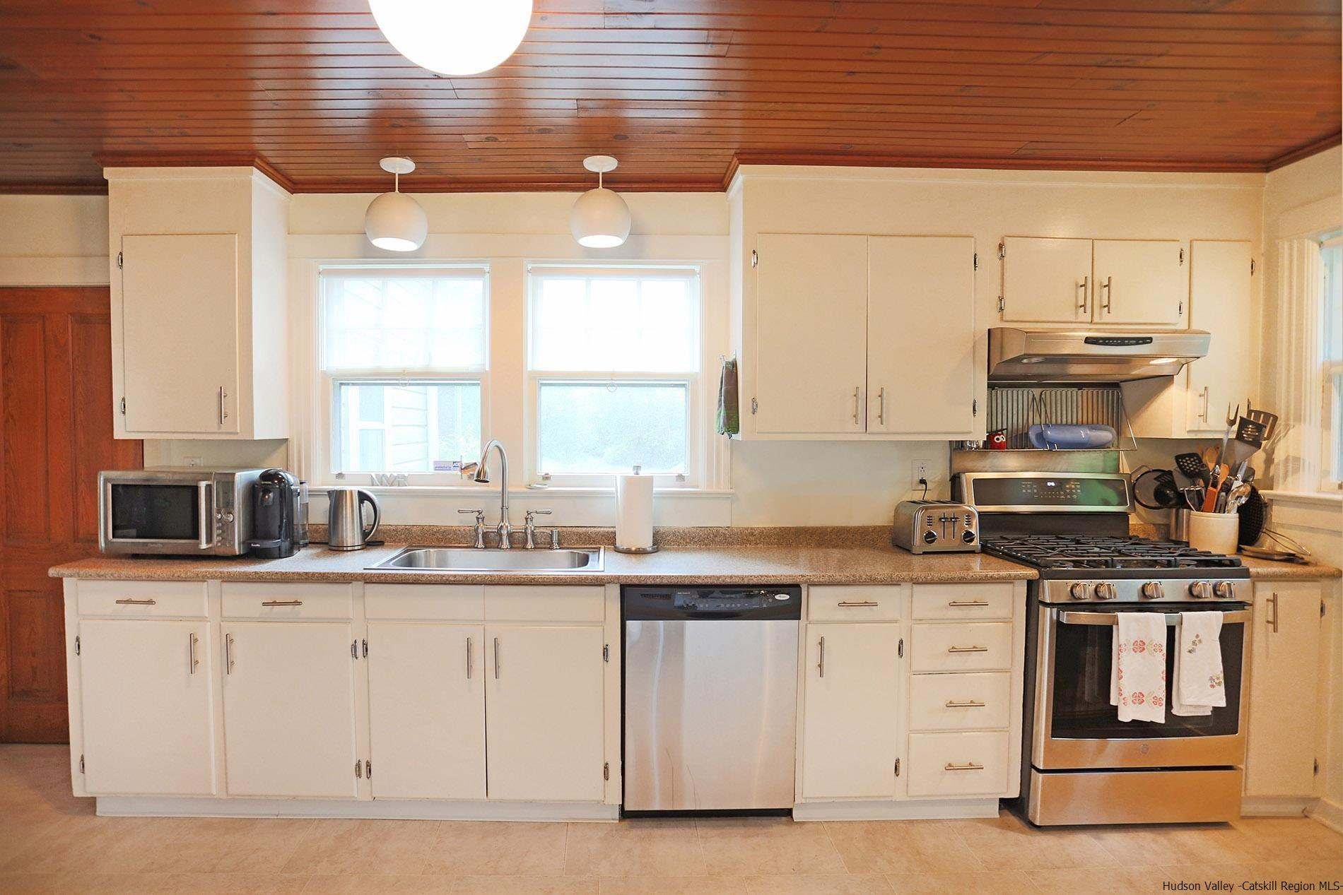 122 Peak Road Stone Ridge, NY 12484 - Photo 18 of 35 a kitchen with granite countertop a sink stainless steel appliances and cabinets