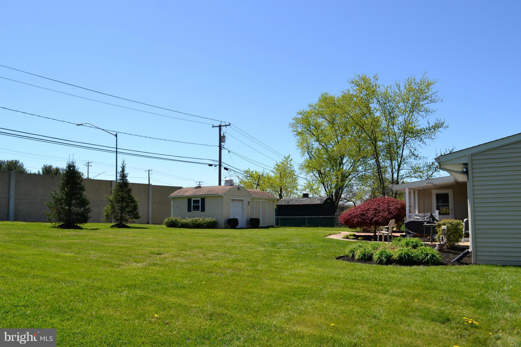 6421 Chell Road Columbia, MD 21044 - Photo 20 of 25 a view of a house with a big yard potted plants and large tree